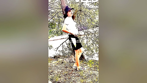 Indian brunette in outdoors film with herself on a laptop