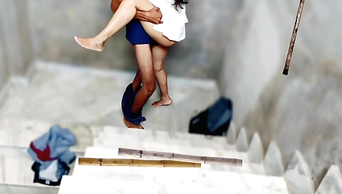 Brunette with a long hair is with her classmate on ladder