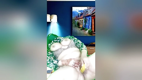 A girl with big boobs plays with herself with a vibrator