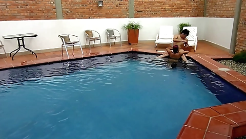 Indian girl is in the pool and plays with her legs