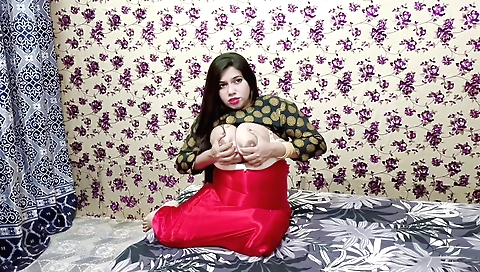 A sexy brunette in a sexy red silk saree in a web video