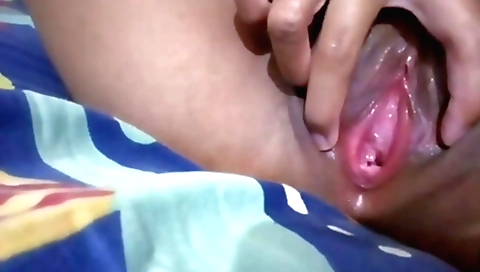 Busty Indian chick with a lustful face is playing with her pussy