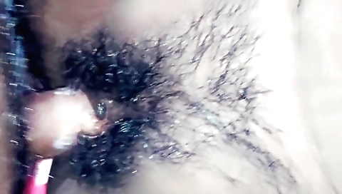 A hairy girl with natural boobs enjoys the way her pussy is stretched