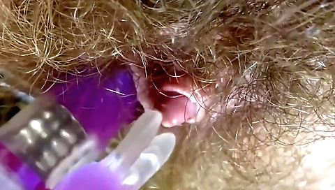 hairy babe with a round booty is playing with a big toy